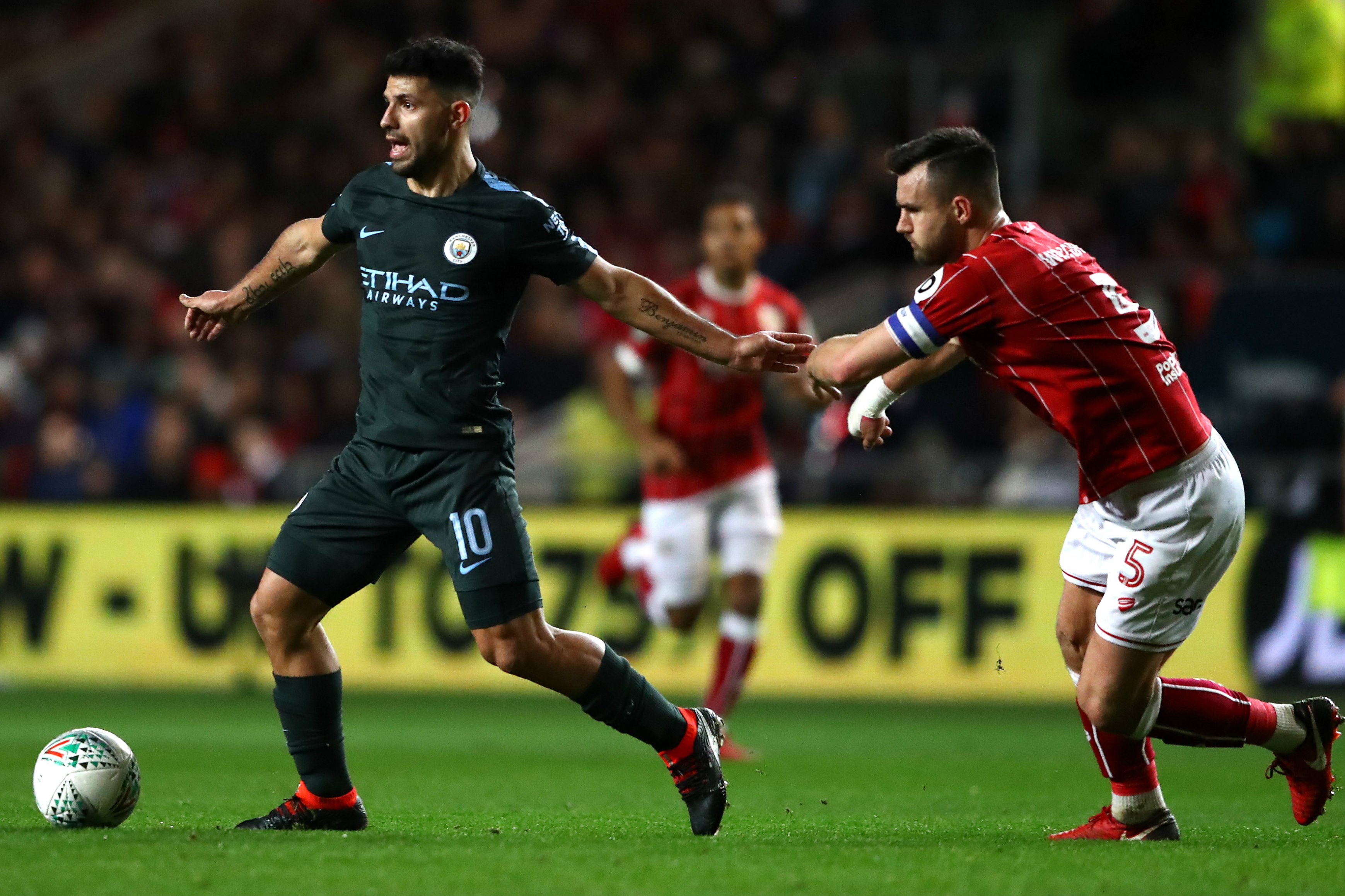 Bailey Wright puts the pressure on City star Sergio Aguero.