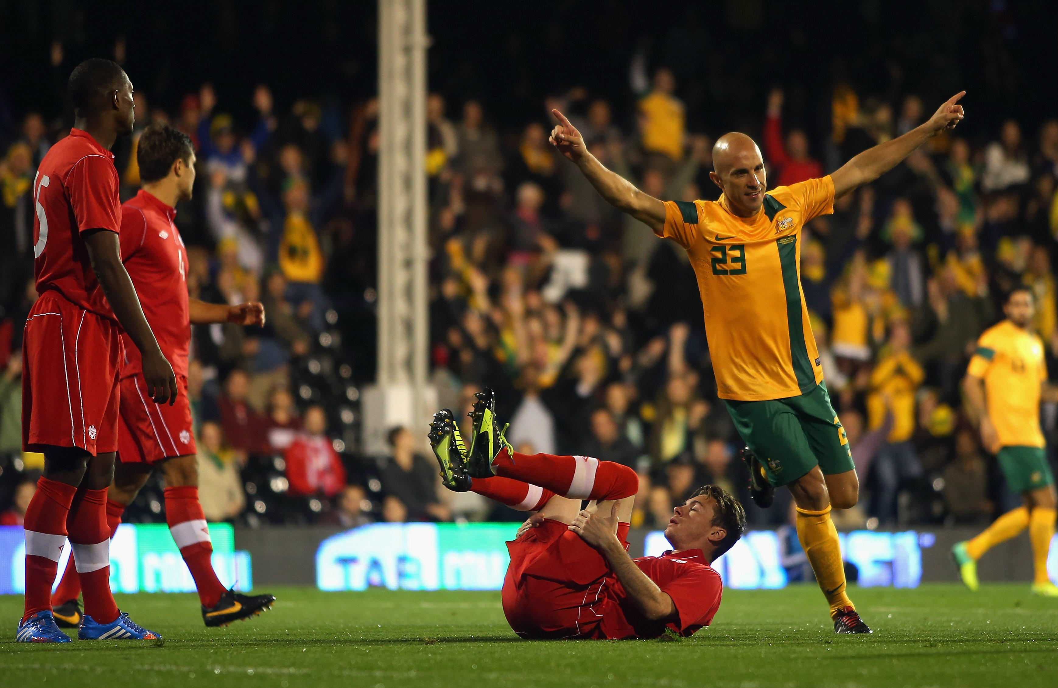 Mark Bresciano celebrates one of Australia's goals against Canada.