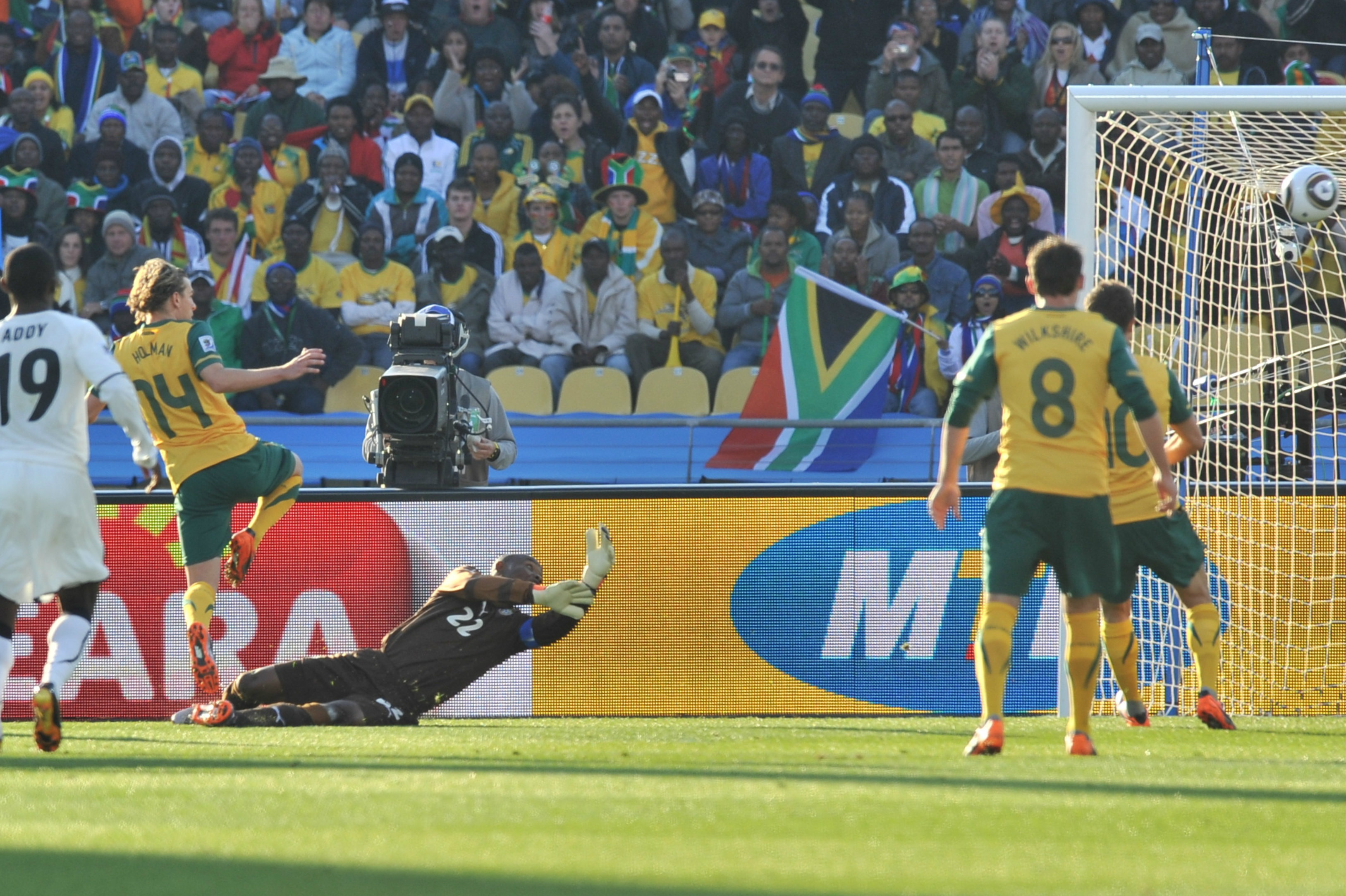 Brett Holman fires into the net against Ghana.