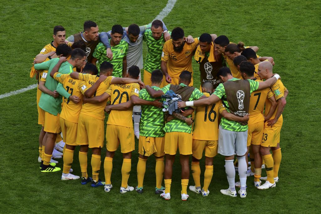 Socceroos players huddle after the France game