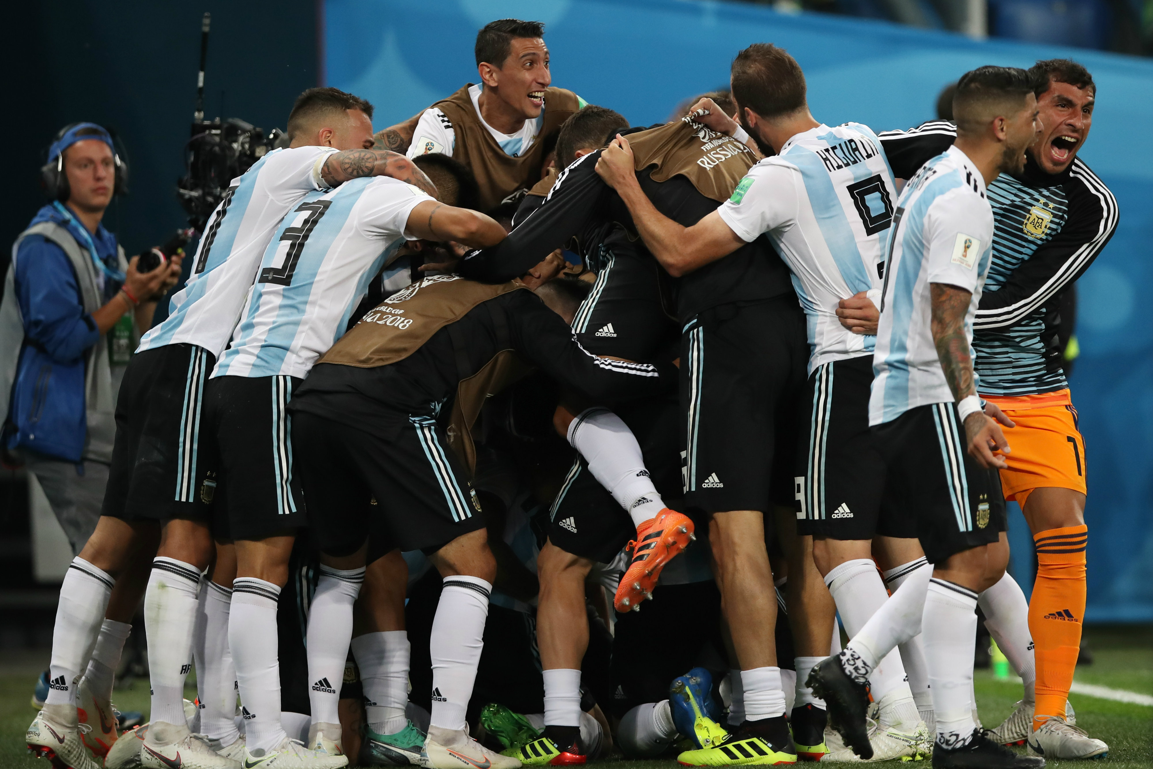 Argentina players swamp Marcos Rojo after his winning goal. Argentina players swamp Marcos Rojo after his winning goal.