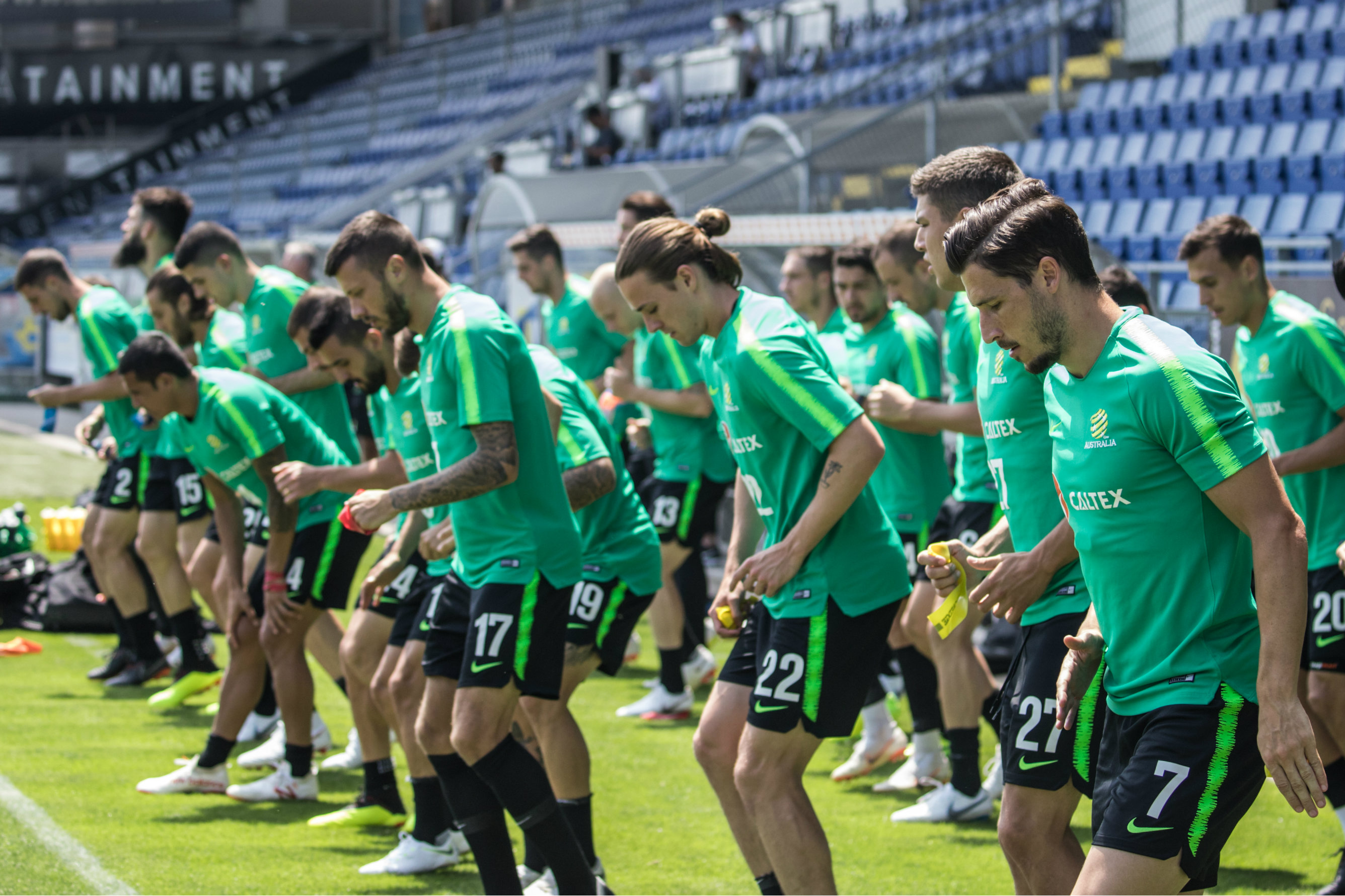 The Caltex Socceroos warm up before starting training.