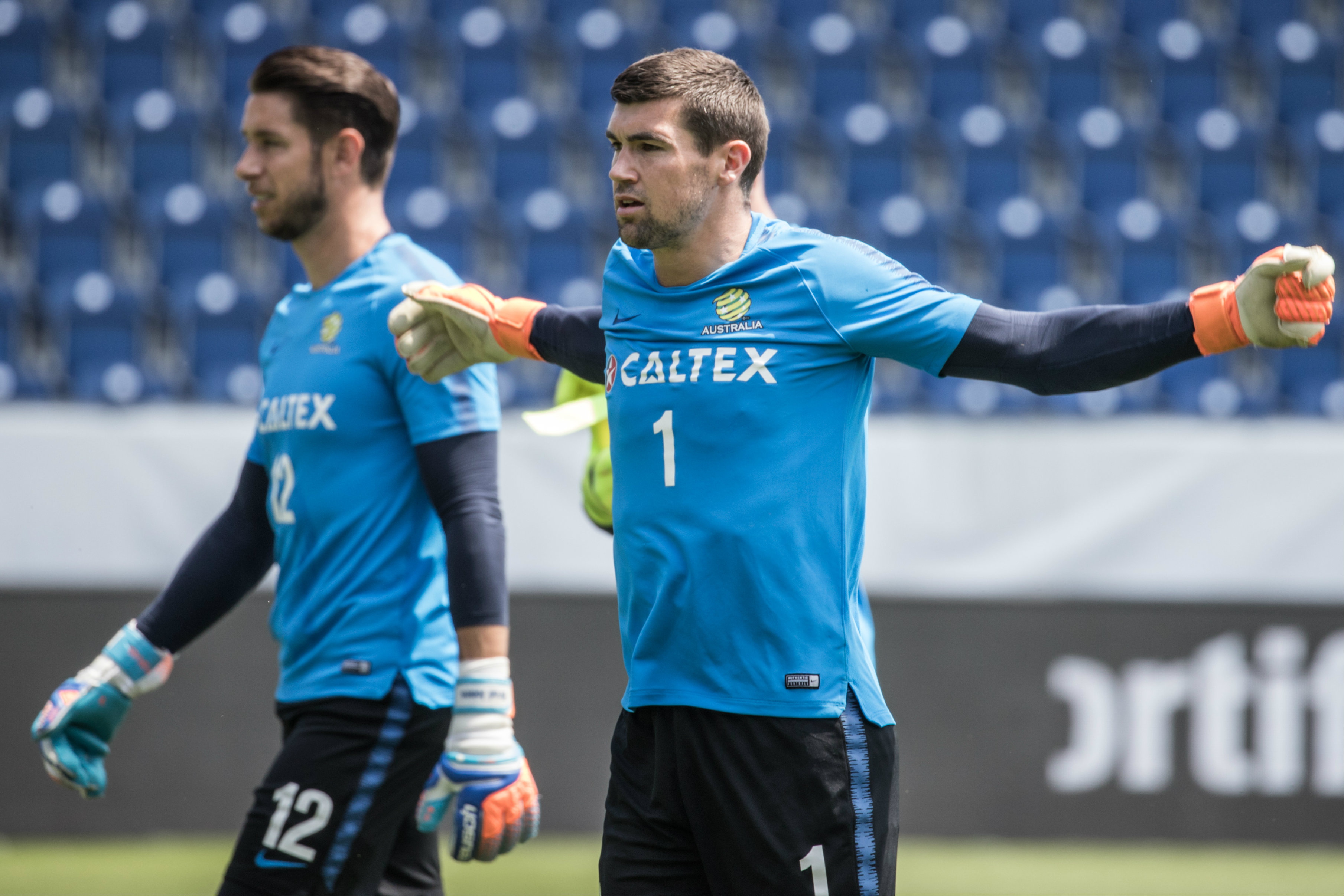 Goalkeeper Mat Ryan limbers up for the session.