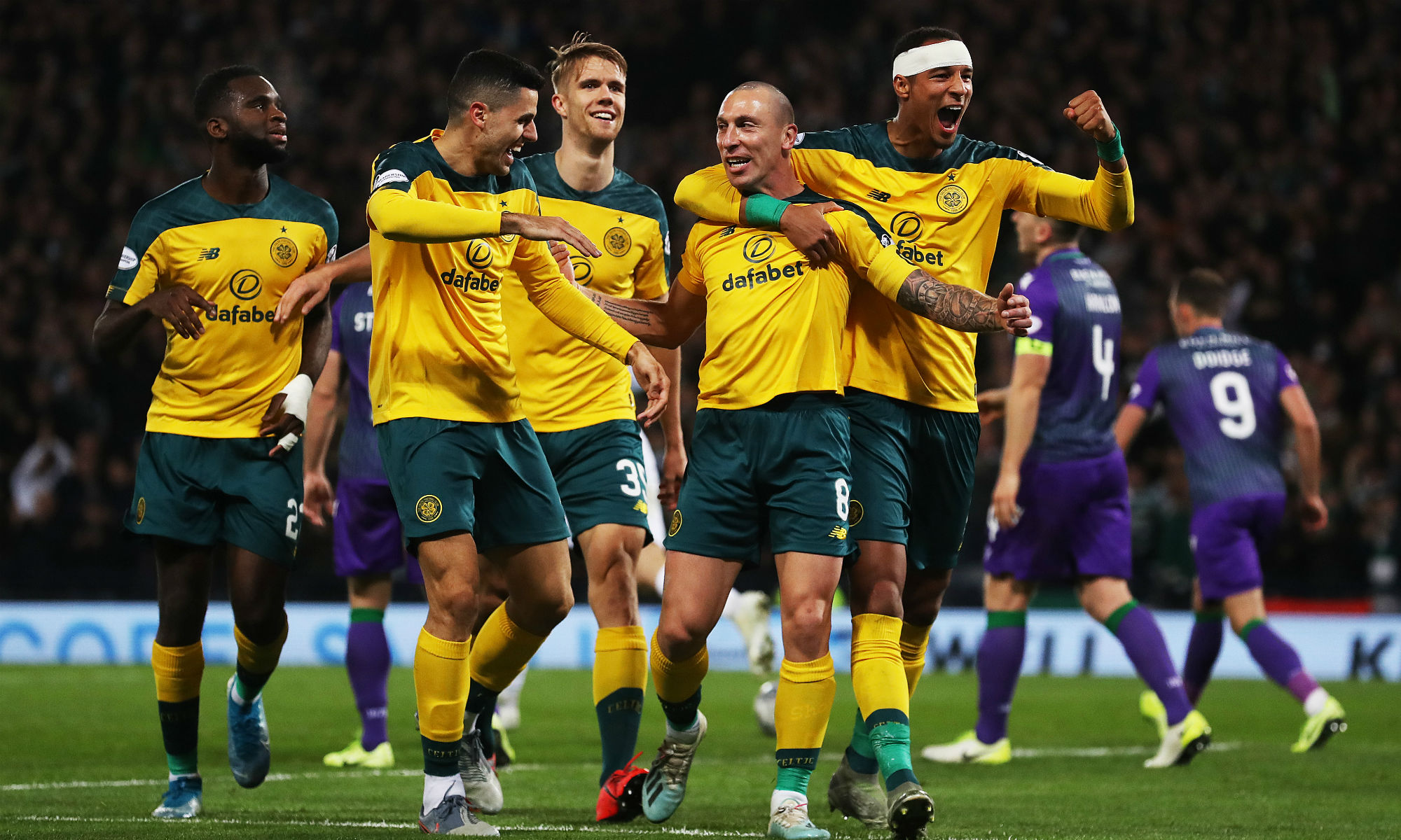 Tom Rogic celebrates with Celtic goalscorer Scott Brown