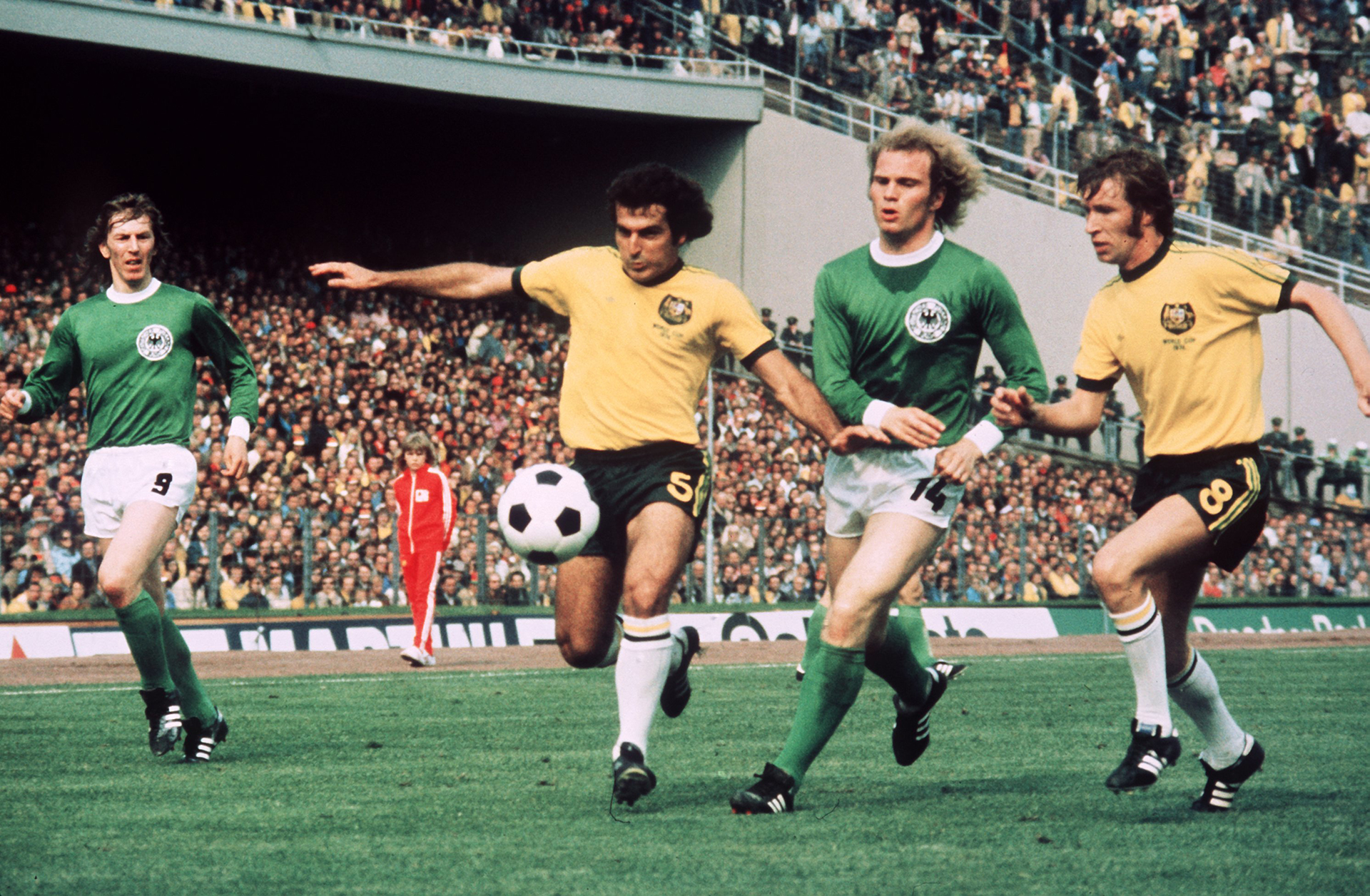 Colin Curran (2nd from L) and midfielder James Mackay (R) manage to stop German midfielder Uli Hoeness (2nd from R) and take the ball off him