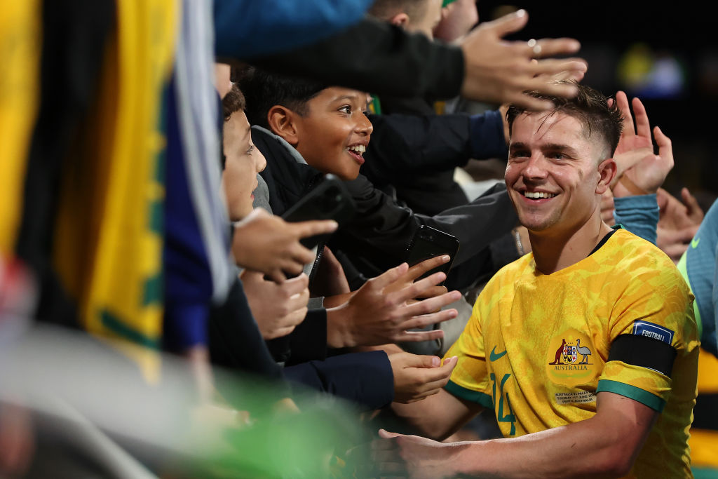 PERTH, AUSTRALIA - JUNE 11: Cameron Devlin of Australia celebrates with supporters following the Second Round FIFA World Cup 2026 Qualifier match between Australia Socceroos and Palestine at HBF Park on June 11, 2024 in Perth, Australia. (Photo by Paul Kane/Getty Images)