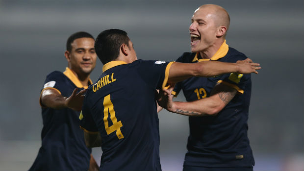 Socceroos James Meredith, Tim Cahill and Aaron Mooy celebrate scoring against Bangladesh in Dhaka.