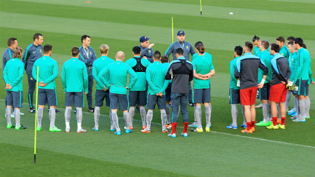 The Socceroos squad take instructions from coach Ange Postecoglou in Perth.