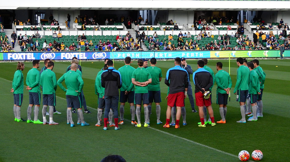Socceroos players are given instructions from Ange Postecoglou during the session at nib Stadium.