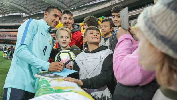 Caltex Socceroos striker Tim Cahill poses for a photo with fans at the team's Fan Day in Adelaide.