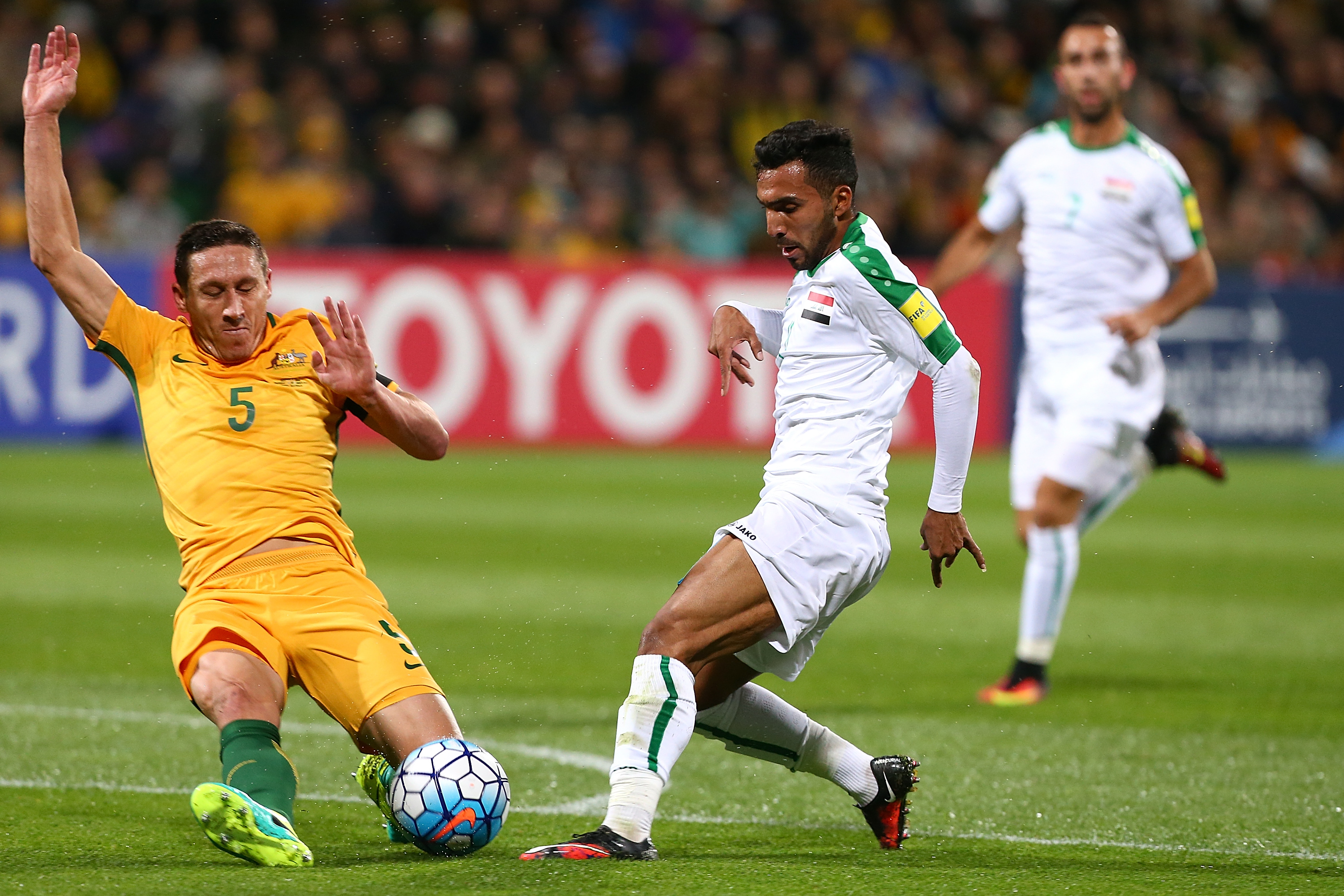 Iraq threatened on the counter attack with Mark Milligan forced into a desperate challenge on Ali Hisny Faisal.