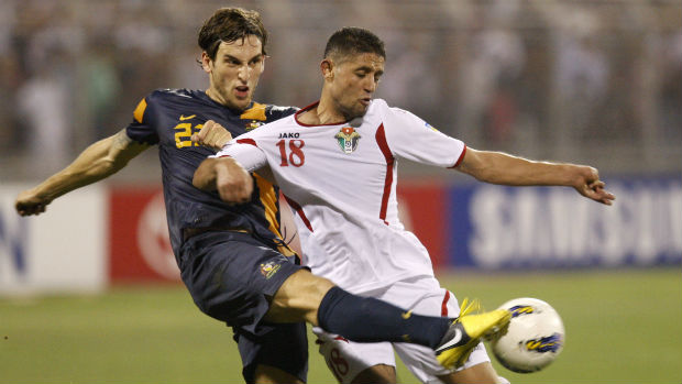 Matthew Spiranovic makes a defensive intervention against Jordan.