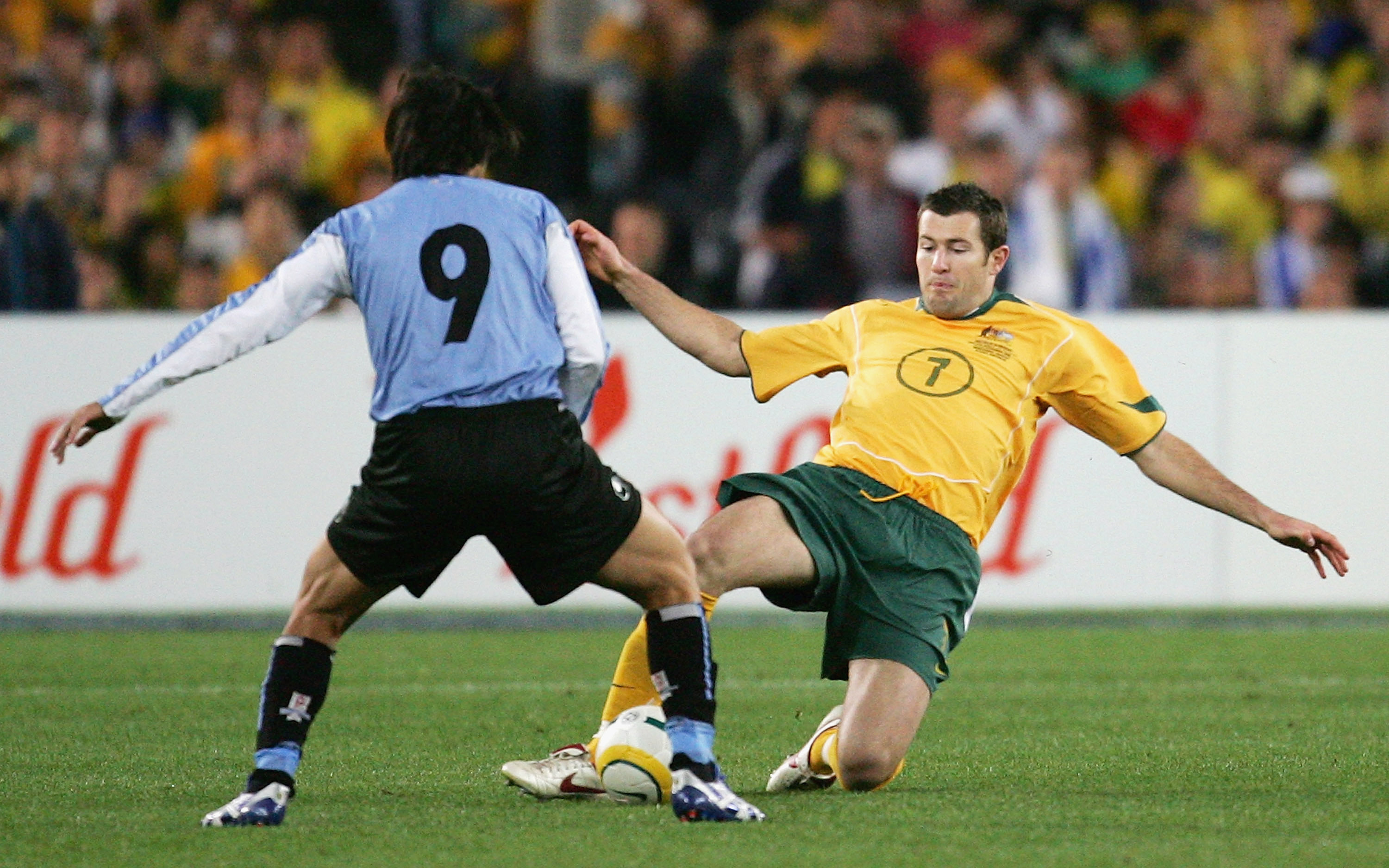 The tireless Brett Emerton challenges for the ball with Uruguay's mercurial playmaker Alvaro Recoba.