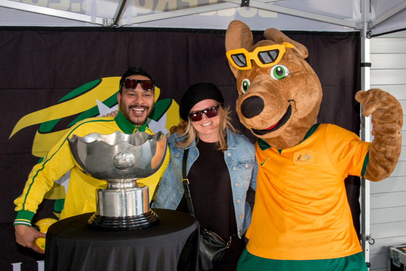 Socceroos mascot Maloo poses with fans and the AFC Asian Cup.