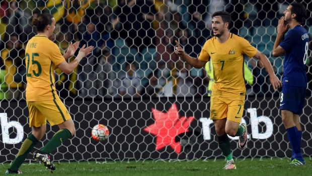 Mat Leckie celebrates his late winner against Greece with Jackson Irvine.