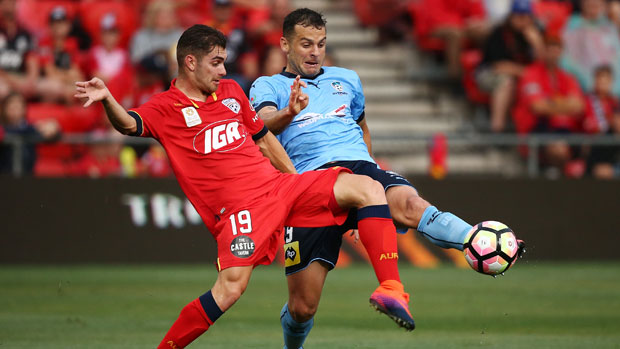 Adelaide's Ben Garuccio fights for the ball with Sydney FC striker Bobo.