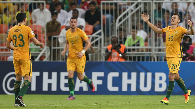 Trent Sainsbury celebrates scoring against Saudi Arabia with Tom Rogic and Tomi Juric.