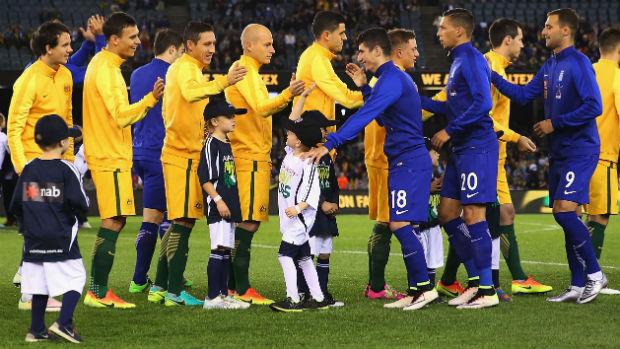 Socceroos and Greece players shake hands before kick-off at Etihad Stadium in Melbourne.
