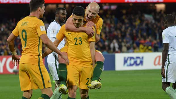 Aaron Mooy celebrates Tom Rogic's goal against Saudi Arabia.