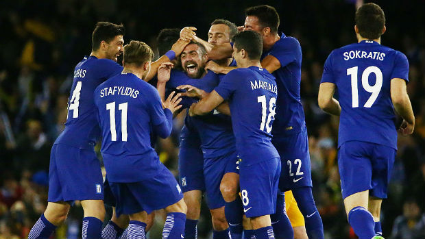 Greece players celebrate Iaonnis Maniatis' long range stunner against the Caltex Socceroos.