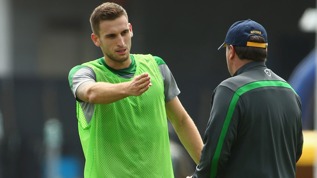 Spiranovic speaks with Socceroos coach Ange Postecoglou during a training session in Melbourne.