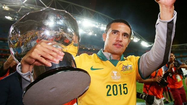 Socceroos striker Tim Cahill holds the Asian Cup aloft at Stadium Australia.