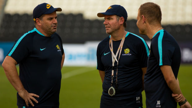 Caltex Socceroos coach Ange Postecoglou talks to assistants Ante Milicic and Josep Gombau.