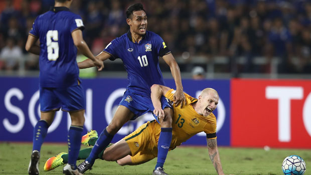 Thailand's Teerasil Dengda challenges for the ball with Socceroos midfielder in November's WCQ.