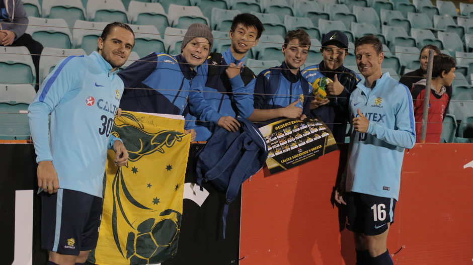 Josh Ridsdon and Nathan Burns with Socceroos fans.