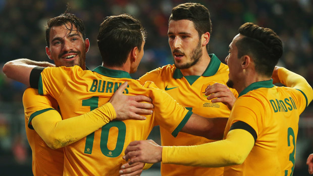 Socceroos players celebrate a goal in their 2-2 draw with Germany in March.