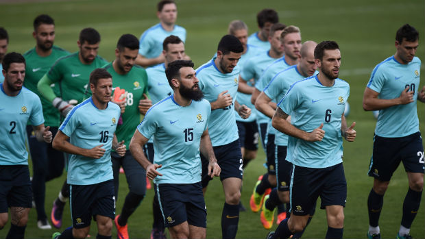 Captain Mile Jedinak leads the Caltex Socceroos on a training warm-up in Bangkok.
