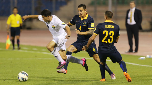 Tim Cahill and Tarek Elrich try to dispossess Jordan's Hamza Aldaradreh in Amman.