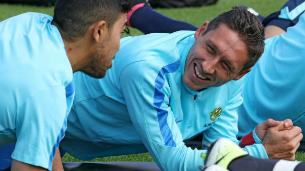 Mark Milligan on the training ground alongside Massimo Luongo.