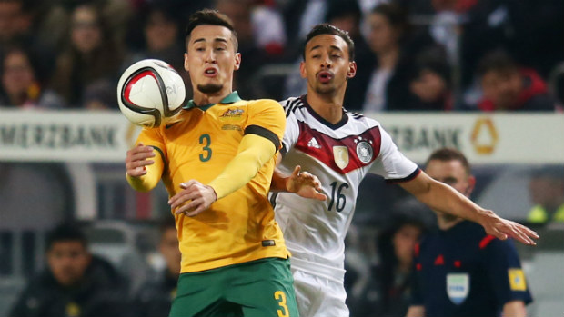 Socceroo Jason Davidson goes up for the ball against Germany's Karim Bellarabi.