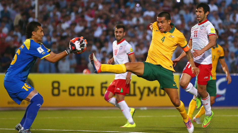 Tim Cahill is just beaten to the ball by Tajikistan's goalkeeper.