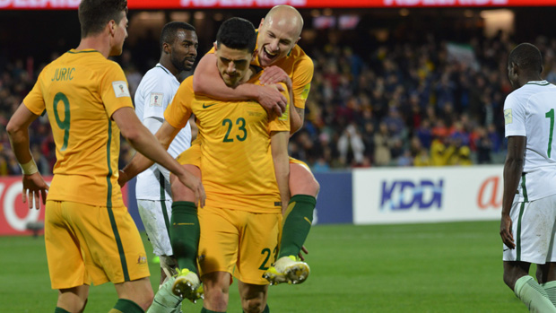 Tom Rogic celebrates with Aaron Mooy after scoring against Saudi Arabia.