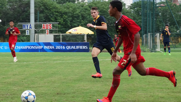 Mark Moric puts pressure on a Myanmar defender.