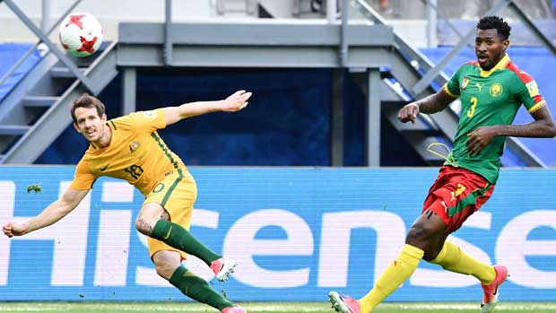 Caltex Socceroos winger Robbie Kruse gets a shot away against Cameroon.