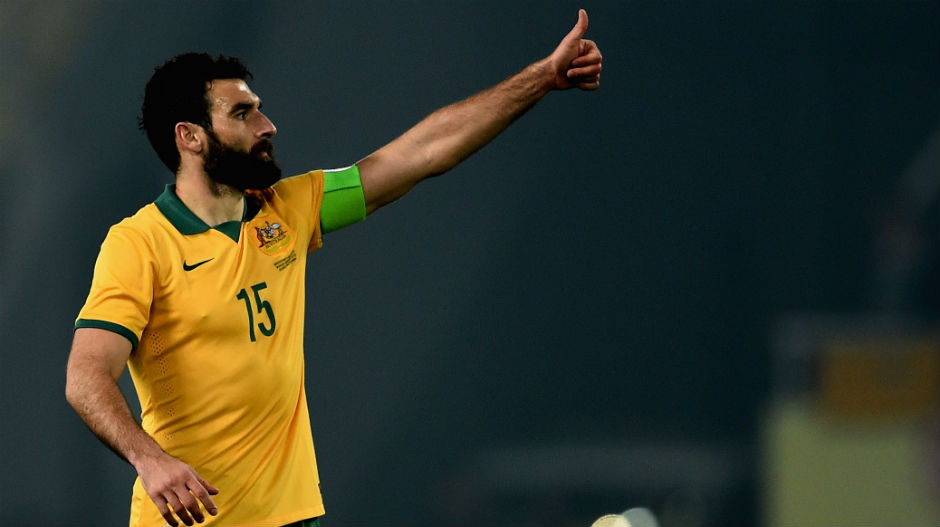 Socceroos captain Mile Jedinak gives the thumbs up to the sideline.