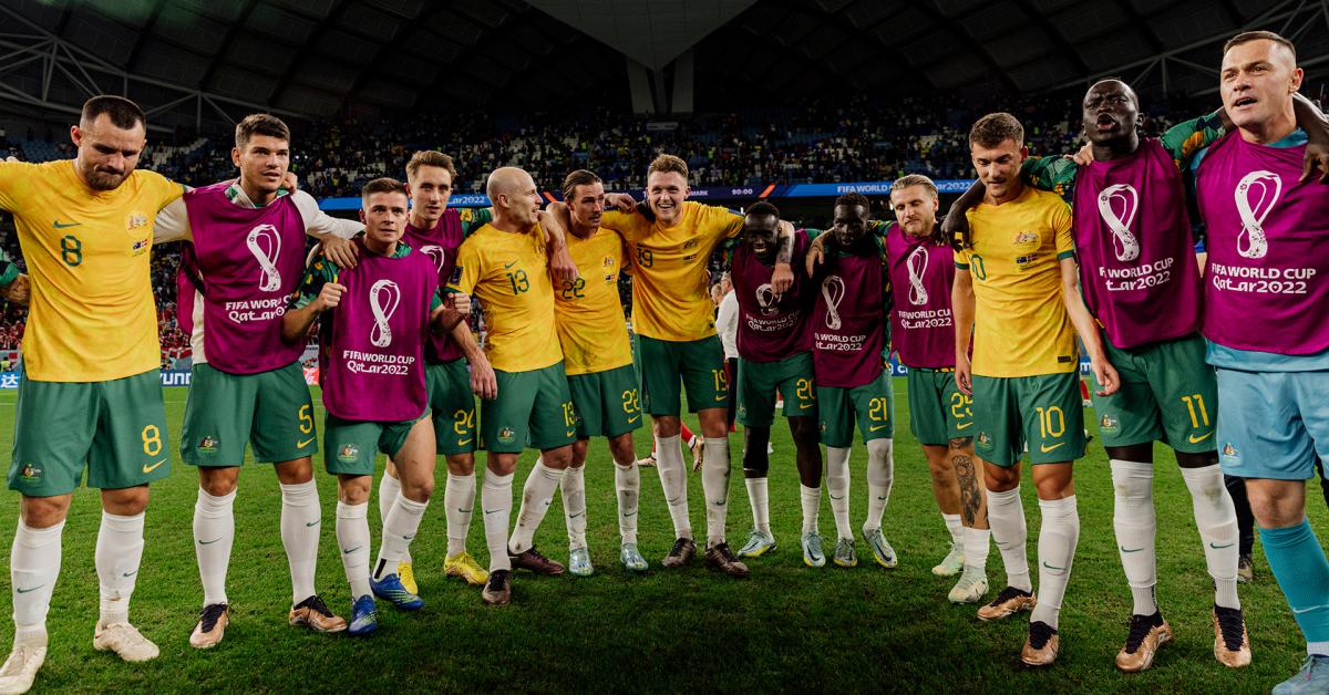Socceroos huddle to celebrate the defeating Denmark at the 2022 World Cup