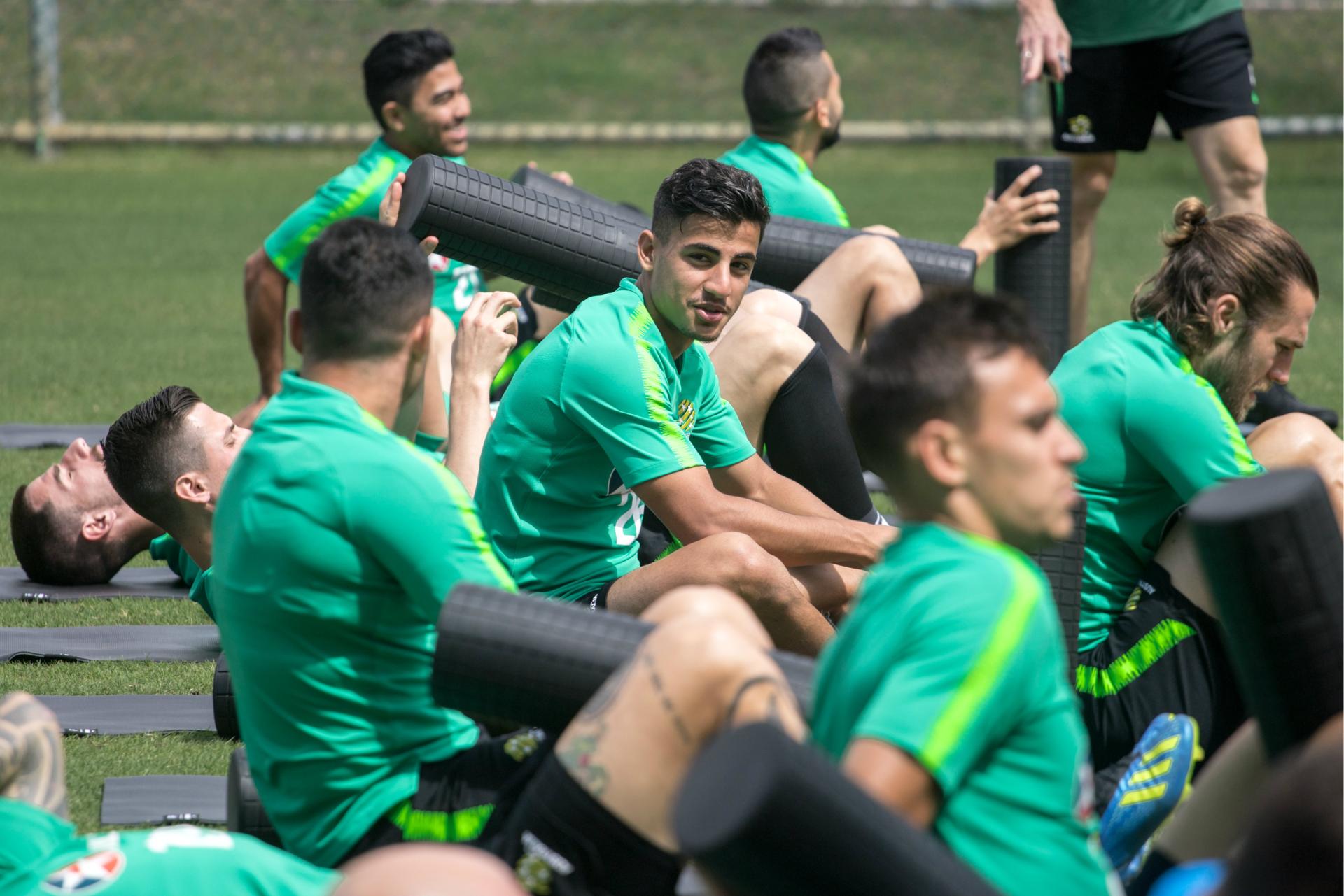 Daniel Arzani and the rest of the squad do their prehab before the session. 