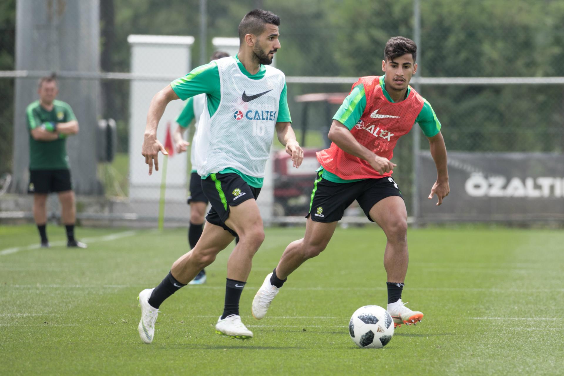 Aziz Behich on the ball under pressure from Daniel Arzani.