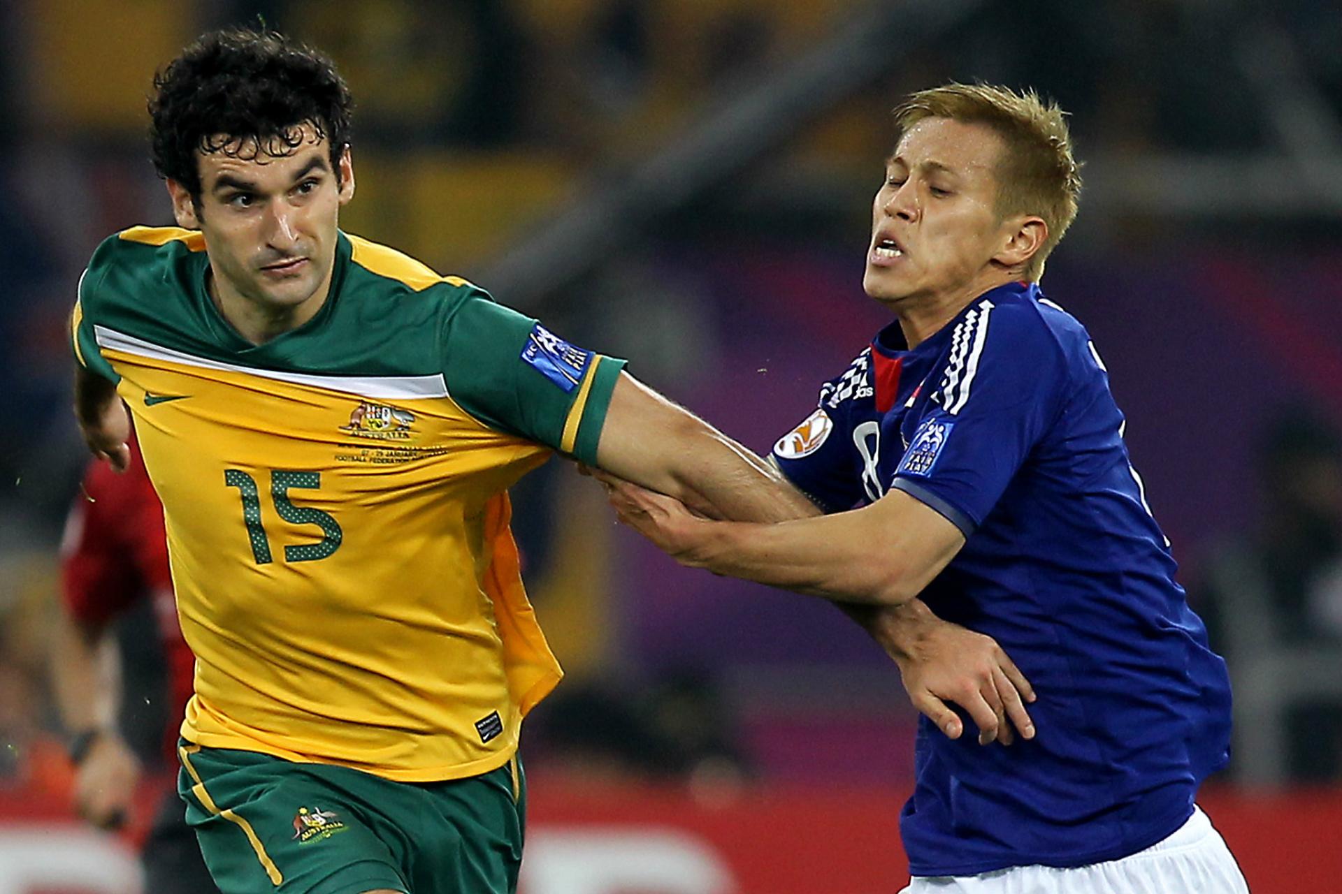 Tussling with Japan's Keisuke Honda in the 2011 AFC Asian Cup final.