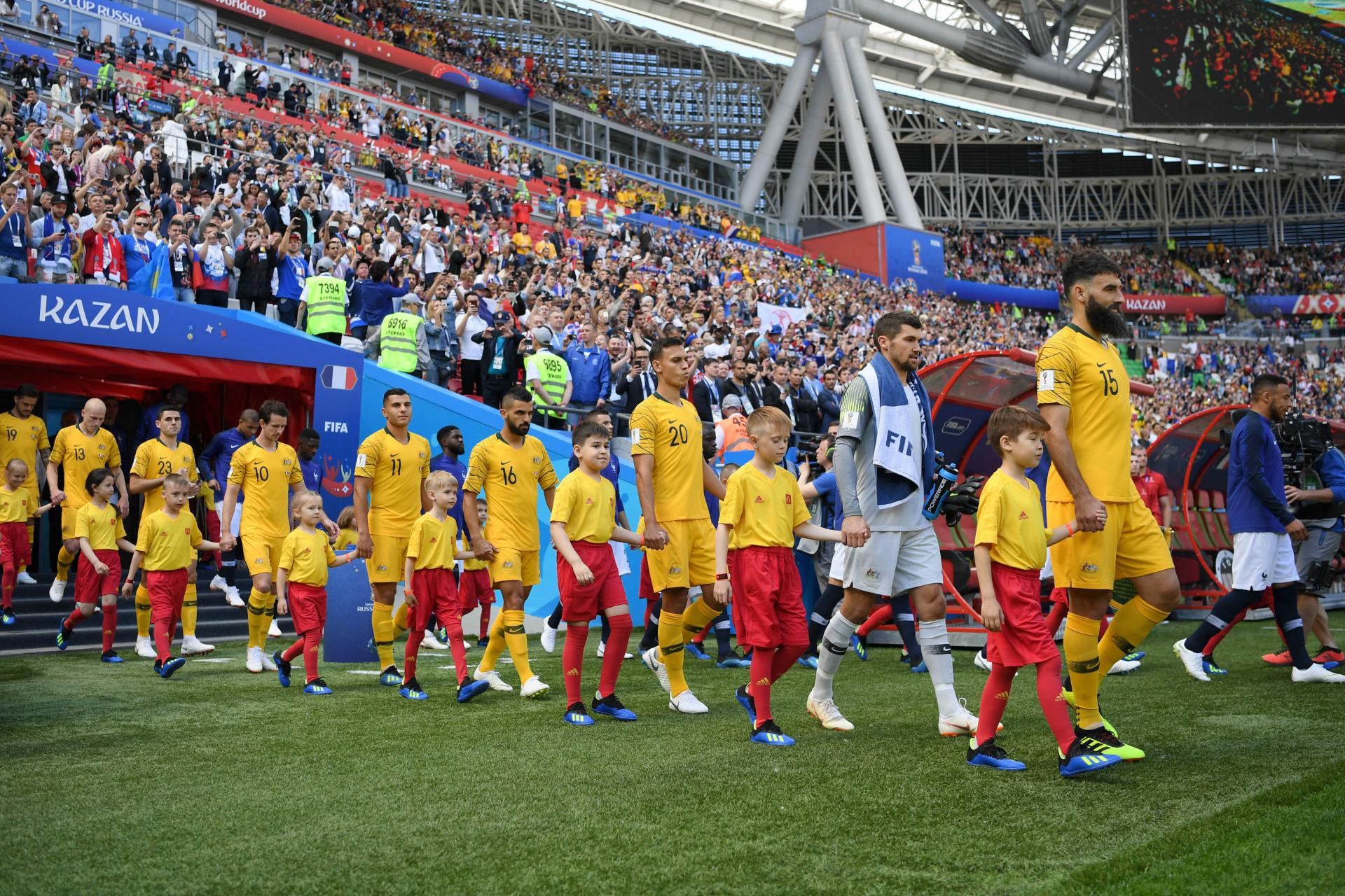 Jedinak leading the Caltex Socceroos onto the pitch for their opening match against France.