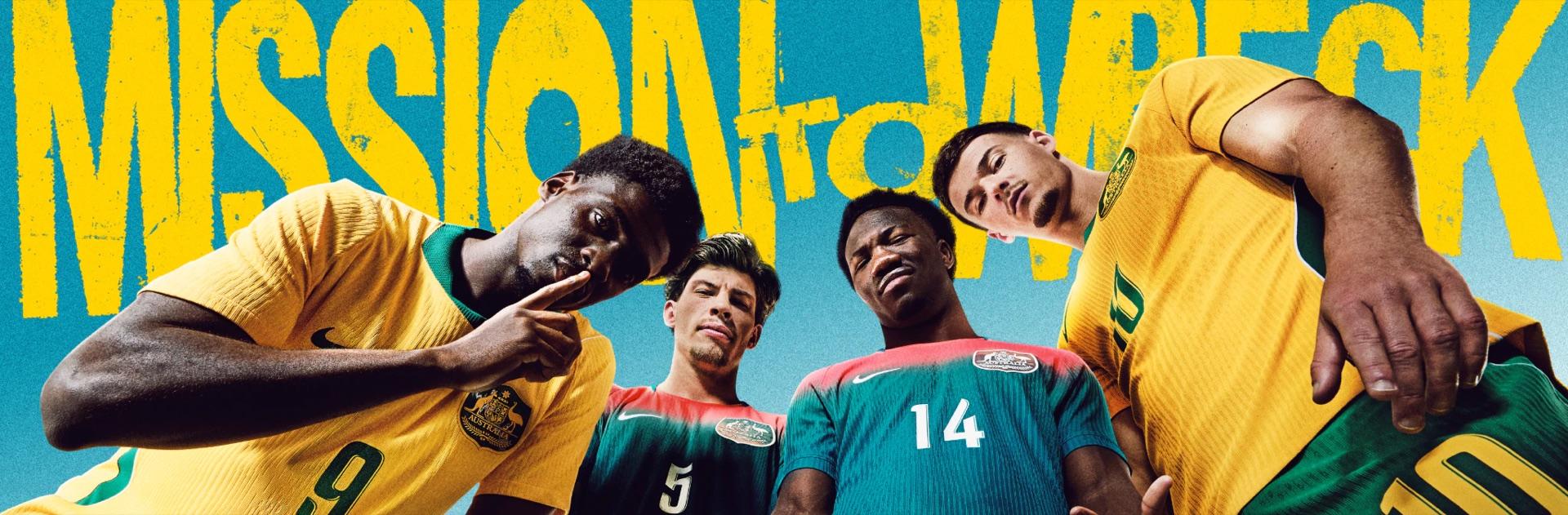 Four Socceroos players in the 2026 home and away kits under a Mission to Win mural