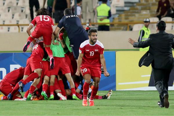 Syria players celebrate a goal in FIFA World Cup qualifying.