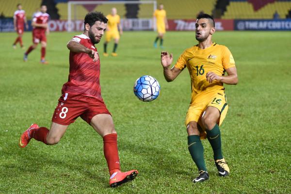 Aziz Behich puts pressure on a Syrian opponent in Malaysia.