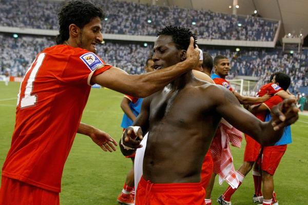 Bahrain players celebrate staying alive in the chase for a 2010 World Cup berth.