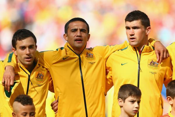 Tommy Oar alongside Tim Cahill and Mat Ryan during the national anthem.