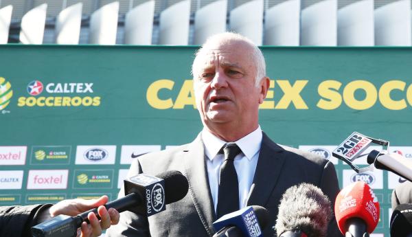 Graham Arnold addresses the assembled media at ANZ Stadium